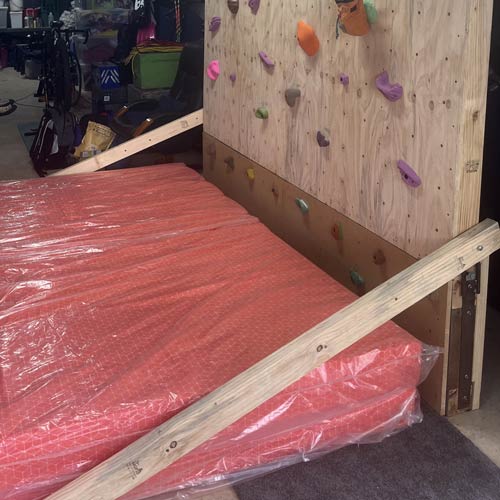 Foam mattress used as padding for a climbing wall